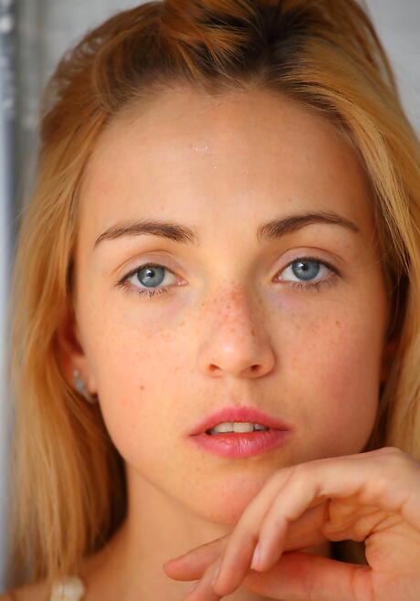 Rangy blond young Ruby exhibits small tits and shaved pussy 